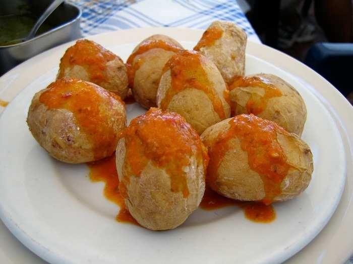 Papas arrugadas are very small potatoes that are boiled in salt water, drained, and slightly roasted before being served with mojo, a sauce consisting of garlic, paprika, red pepper, olive oil, and sometimes cumin.