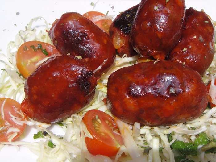 Chorizo al vino is made by slowly cooking smoky chorizo sausage in red wine.