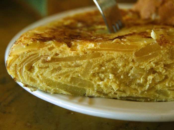 Tortilla de patatas, or tortilla española, is an omelette made with potatoes bound with egg and is usually flavored with onions. As tapas, they are commonly served in small wedges.