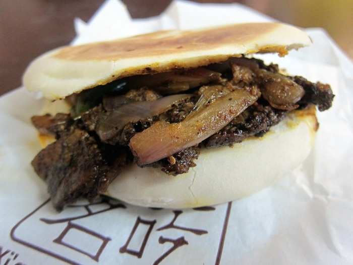 The Chinese version of a burger, iou jia mo is pulled or shredded meat (commonly pork) stuffed into a doughy flatbread bun. The street food originally comes from the Shaanxi province, but can now be found pretty much everywhere in the country.