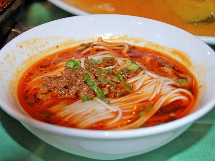 Starting off as a common noodle dish served on the streets of the Sichuan province, dan dan mein is a warm bowl of long, thin noodles swimming in chile oil and topped with minced pork and pickled vegetables.