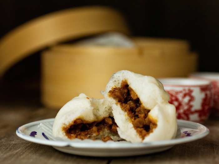 The pork bun (char siu bao) comes from the Cantonese region in China. Pieces of pork seasoned in a sweet barbecue sauce are stuffed inside soft steamed buns.