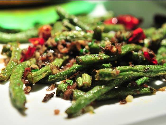 Gan bian si ji dou, or dry fried string beans, has a lot more kick than your average side of green beans. The Sichuan-style string beans are broiled — giving them a crispy texture — and then tossed in peppercorns, scallions, garlic, ginger, and mustard root.