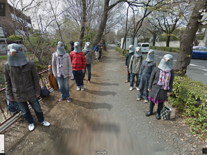 Japanese pigeon people are a shocking find on a sidewalk along the Tamagawa-josui. The picture was taken close to an art school, which could explain the bizarre masks.