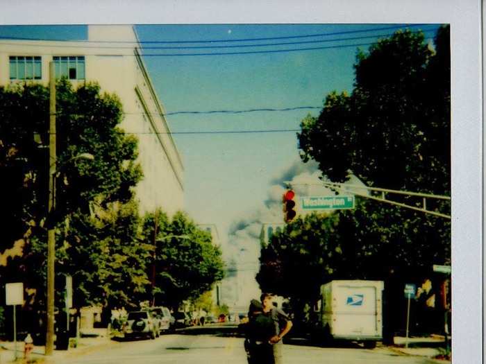 Thinking that there would be thousands of wounded people, I approached this police officer to ask if I could donate blood. He said there was no need: People in the buildings either died or survived. Relatively few were wounded. You can see the smoke in the background at the end of the street.