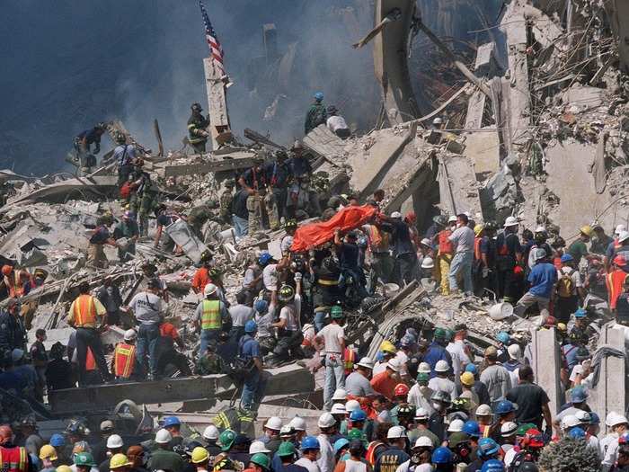 In the days that followed, rescue workers streamed into New York for neighboring cities and states. Scene of horror as bodies were lifted from the rubble contrasted with signs of defiance as American flags were raised above the carnage.