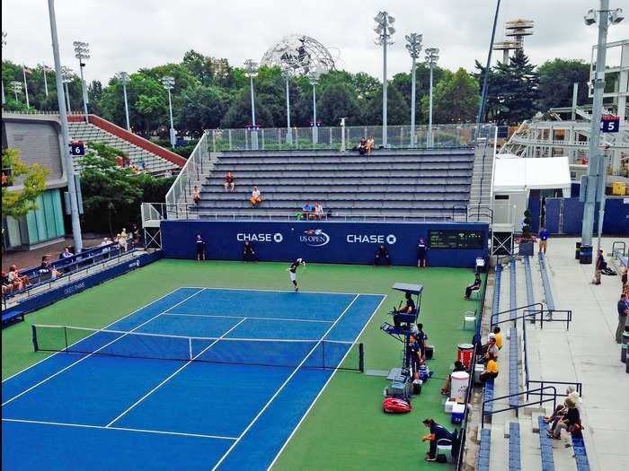 The bank of courts opposite the practice courts were featuring the American Collegiate Invitational quarterfinal matches — the winner will receive a wild card bid to the 2016 US Open.