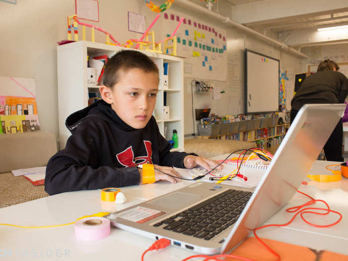 Meanwhile, a classmate plays Pac-Man using MaKey MaKey, a simple circuit board that transforms everyday objects into touchable user interfaces.