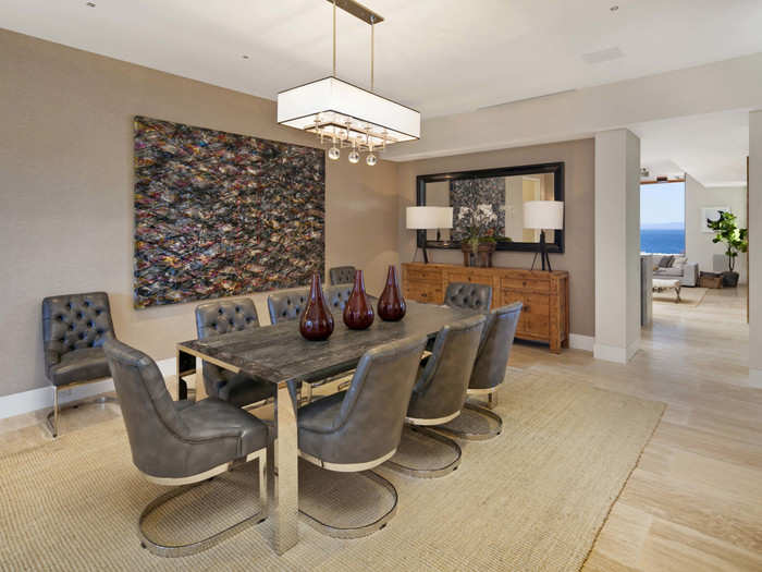 A formal dining room offers plenty of space for guests and shares an aquarium wall with the living room. The aquarium