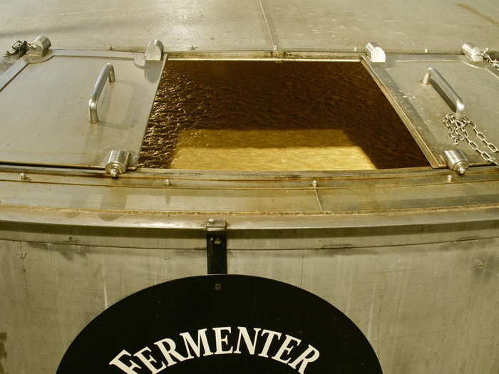 The sour mash is made in one of 64 fermenters. Fine-grain yellow corn, barley, rye and yeast ferment for 4–6 days. The smell was intense and made my eyes water. We all leaned in for a second sniff though.