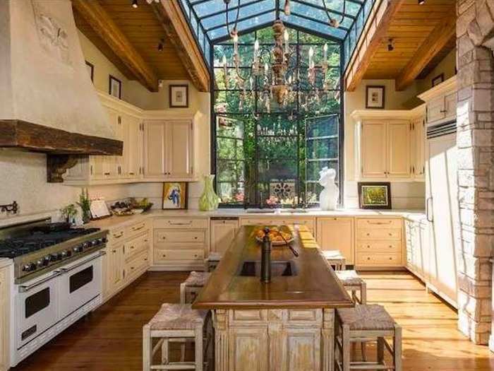 The kitchen has stone wall details and a large island.