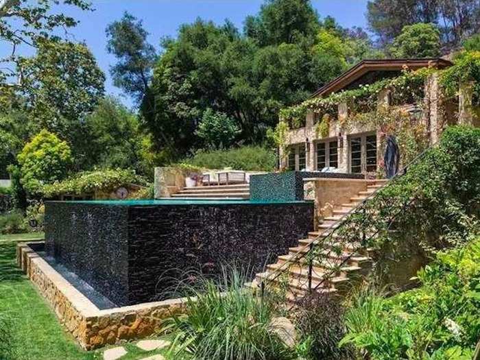 Steps leading down from the pool deck provide access to the rest of the yard.