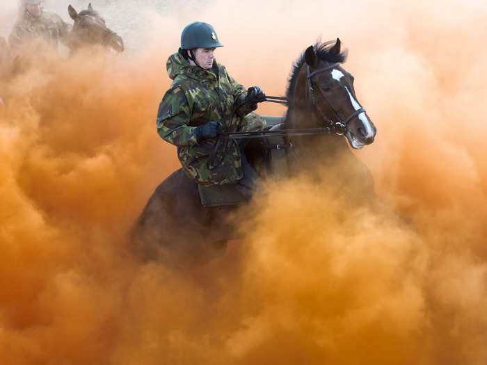 Often soldiers are asked to train with animals. These Dutch gendarmes have to ride their horses through smoke bombs.