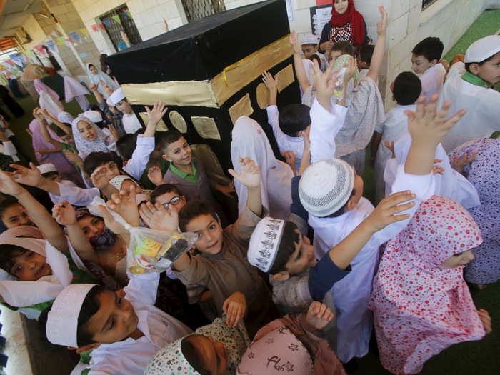 Children are taught the importance of the hajj from a young age. Here, Palestinian children take part in a re-enactment of the annual hajj pilgrimage to Mecca, at their school in the West Bank city of Nablus.