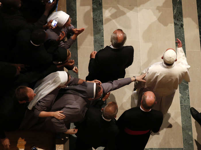 A nun reaches out to touch Pope Francis as he arrives at the Basilica of the National Shrine of the Immaculate Conception for a Canonization Mass for Friar Junipero Serra.