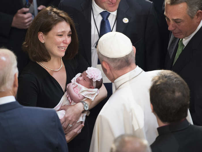 Here, he blesses a young child.