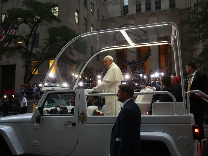 Here, he rides in the famous "popemobile" outside of St. Patrick