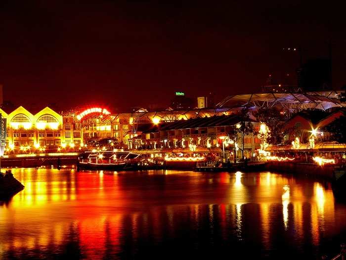 Stroll along Clarke Quay at night, a historical riverside quay that