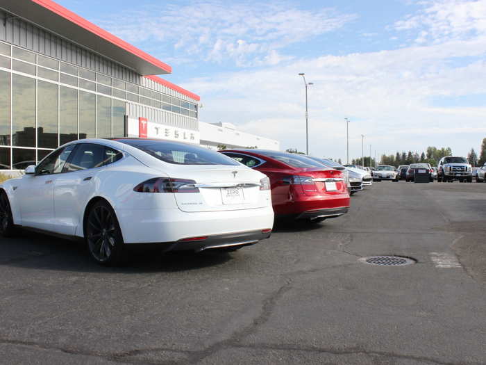 Nearby, brand new Model S cars sit outside the Customer Delivery center.