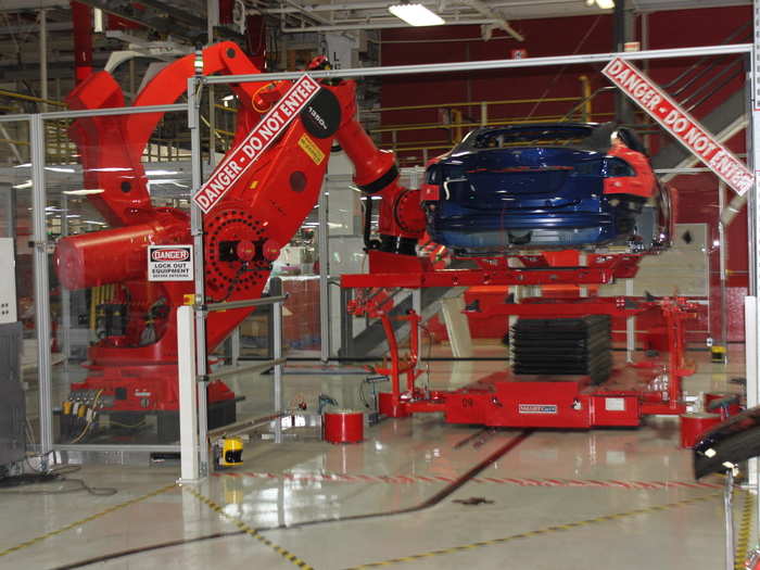 Here, a robot called Mystique is picking up a Model S. The factory