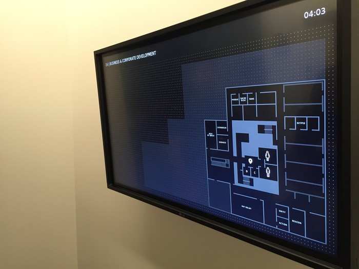Touchscreens in each elevator lobby help employees find their way around the massive building.