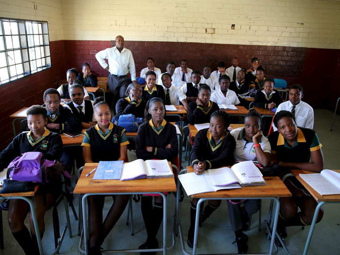 Reginald Sikhwari poses for a picture with his class of 11th-grade students at Sekano-Ntoane school in Soweto, South Africa. In 1976, students in Soweto took part in a famous uprising against the country