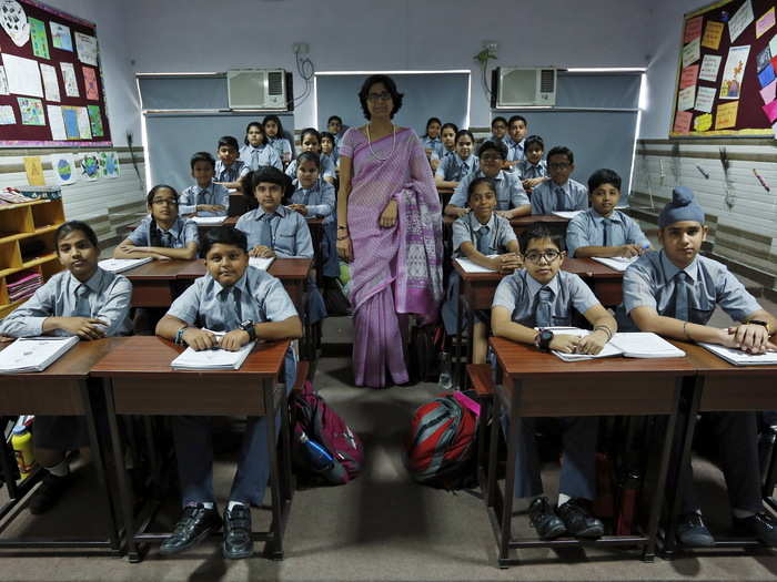 In New Delhi, India, Archana Shori teaches 7th-grade students inside their classroom at Rukmini Devi Public School.