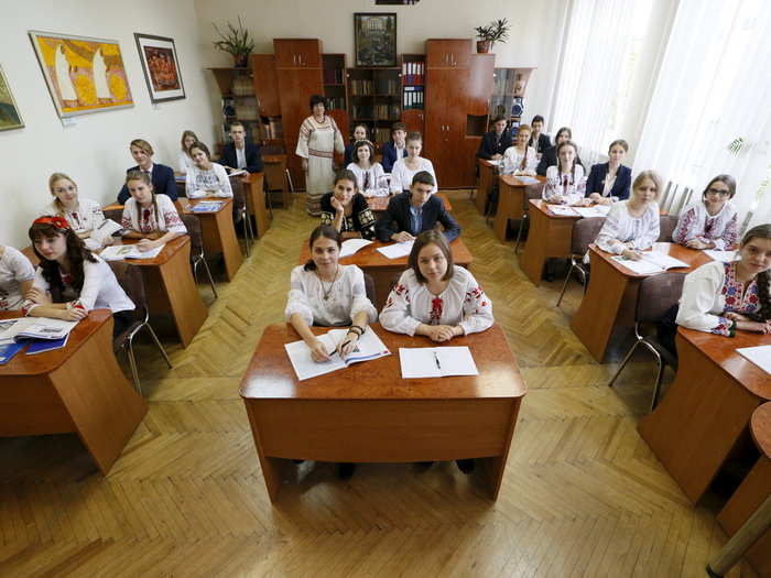 Art teacher Hanna Snitko poses for a picture with her final year students, aged 16 to 17, at the Ukrainian Humanities Lyceum in their classroom in Kiev, Ukraine.