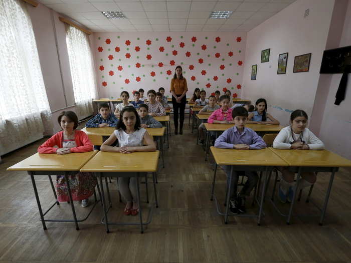 Ekaterine Tsipuria poses for a picture with year five schoolchildren at a public school in Tbilisi, Georgia. The country was disrupted by the outbreak of war with Russia in 2008, and it has struggled to get back on its feet.