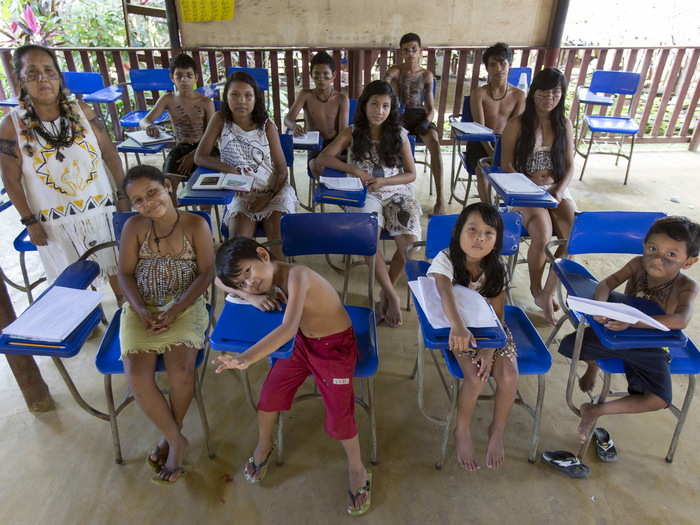 Children of the Satere Mawe Indian tribe school pose for a picture in the village of Sahu Ape, located in the Brazilian state of Amazonas. The tribe has a population of around 13,000 people whose main economic activity revolves around the cultivation of guaraná, a stimulant plant with twice the concentration of caffeine as coffee beans.