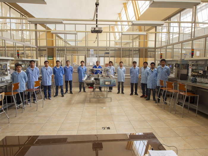 A class in the Don Bosco Technical College pose for a picture in Quito, Ecuador. The 2008 Constitution of Ecuador eliminated tuition for public universities; now, admission is based on aptitude tests taken by applicants.