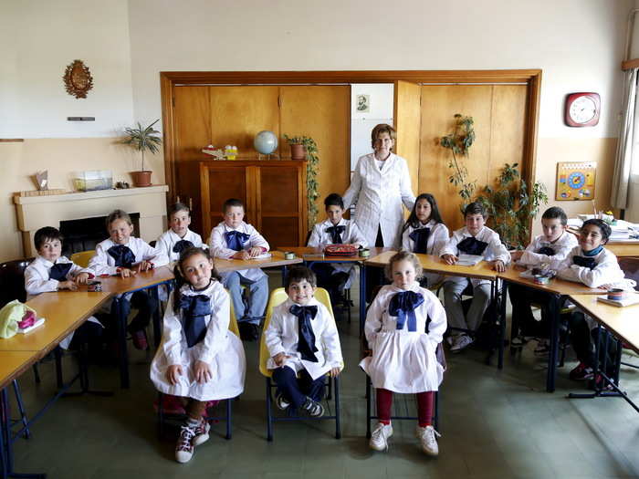 Ana Dorrego poses with her students at the rural school Agustin Ferreira, on the outskirts of Minas, Uruguay. The school has 12 students aged four to 11, with only one teacher. Activities include milking cows, planting vegetables, and cooking.