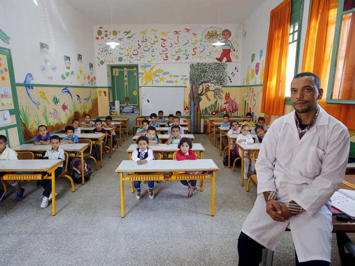 Teacher Moulay Ismael Lamrani sits with his class in the Oudaya primary school in Rabat, the capital of Morocco.