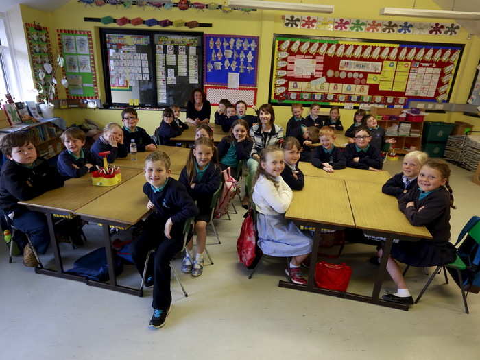 Pupils from Mill Strand Integrated Primary School in the Northern Ireland town of Portrush smile for the camera with their teacher, Mrs. Martin.