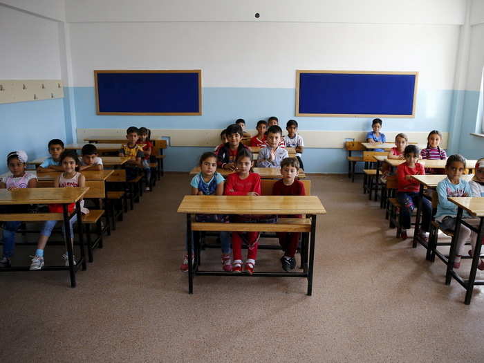 Here, second-grade Syrian refugee students wait for the start of their lessons at Fatih Sultan Mehmet Primary School in Ankara, the capital of Turkey.