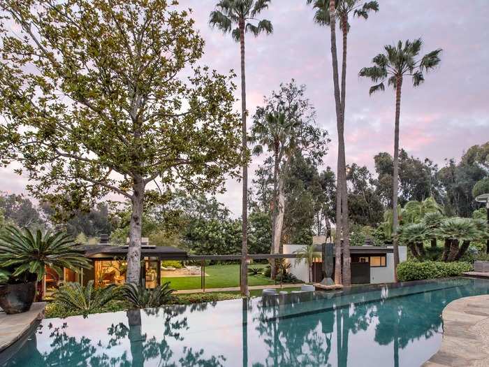 The backyard includes a beautiful cascading infinity pool. It sits between the two homes.