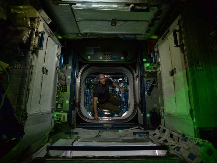 A lone astronaut peers up from a door.