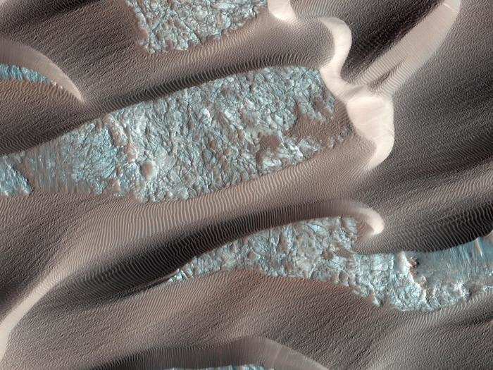 Nili Patera is a caldera about 1.2 miles deep filled with rapidly moving sand dunes and ripples, shown here. This is one of the most active regions on Mars and is located near the equator, west of the third-largest impact basin on the planet, Isidis.