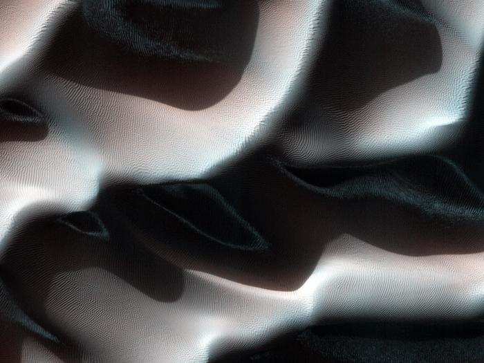 Tall sand dunes in the southern hemisphere cast their shadows in this dramatic shot, which was taken during late autumn. Those white and blue streaks within the shadowed regions are early frost — a sign of the coming winter.