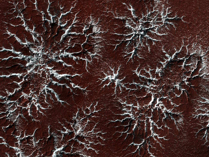 When temperatures heat up in the Spring, the carbon-dioxide ice in the polar caps sublimates into the atmosphere, leaving behind these distinct starburst patterns. Why the melting process makes these characteristic patterns is a subject of ongoing research.