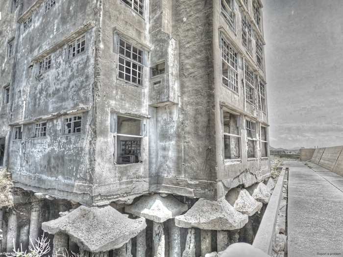 Hashima, and its multitude of enchanting apartment blocks, is entirely surrounded by a sea wall — just visible on the right of this image.