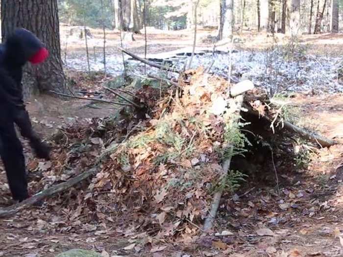 Cover the entire shelter with brush and evergreen for a secure place to stay.