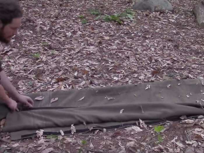 Fold the blanket over one of the logs and under the other, and the stretcher can be used to carry someone.