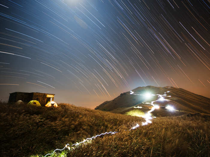 This rural setting in Sunset Peak on Lantau Island, Hong Kong is a stark contrast to hustle and bustle we usually attribute to one of the most densely-populated metropolises. Here, Hong Kong-based photographer Chap Him Wong has exposed his camera long enough to catch the motion of stars as they move across the sky.