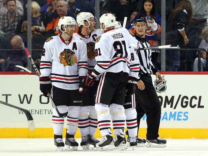 Duncan Keith (2), Marian Hossa (81) and Jonathan Toews celebrate with Patrick Kane (88) after he netted the game winning goal on the power play. The Blackhawks won 3-2.