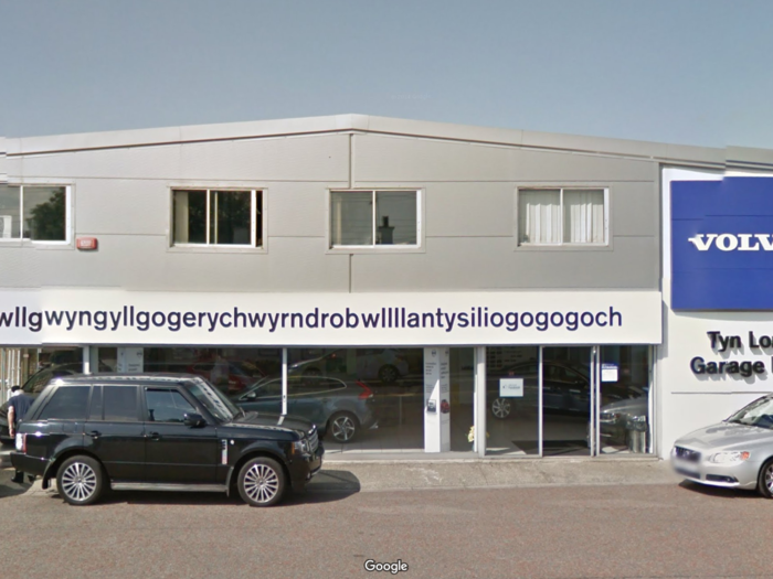 The sign for the local Volvo dealership in Llanfairpwllgwyngyllgogerychwyrndrobwllllantysiliogogogoch runs the entire length of the building.