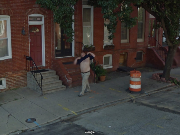 A man flashes the Google Maps car cameras in Baltimore, Maryland.