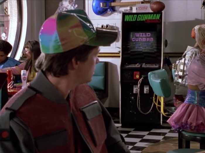 In the movie, Marty McFly plays a game called "Wild Gunman" — a quick draw shooting challenge.