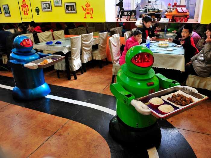 Robots deliver dishes to customers at a restaurant in Harbin, China. Opened in June 2012, the restaurant has become famous for using 20 robots to cook meals and deliver dishes. The robots can work continuously for five hours after a two-hour charge, and they