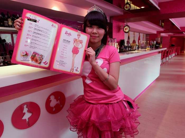 Employees serve customers during the media preview of a Barbie-themed cafe in Taipei in 2013. The 7,000 square-foot Barbie Cafe, which has since closed, had decor and dishes that were inspired by Mattel